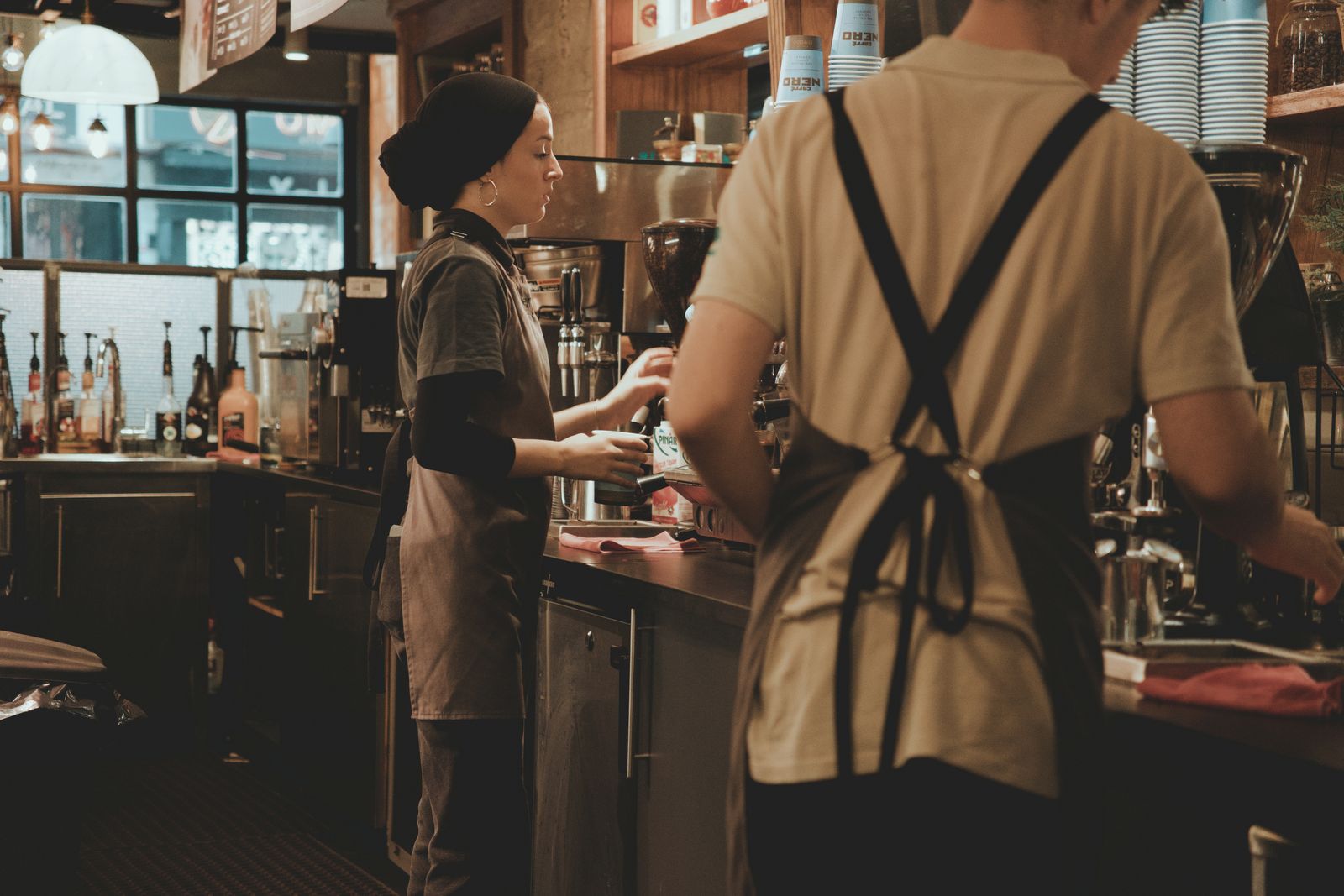 Baristas working side by side on a busy bar